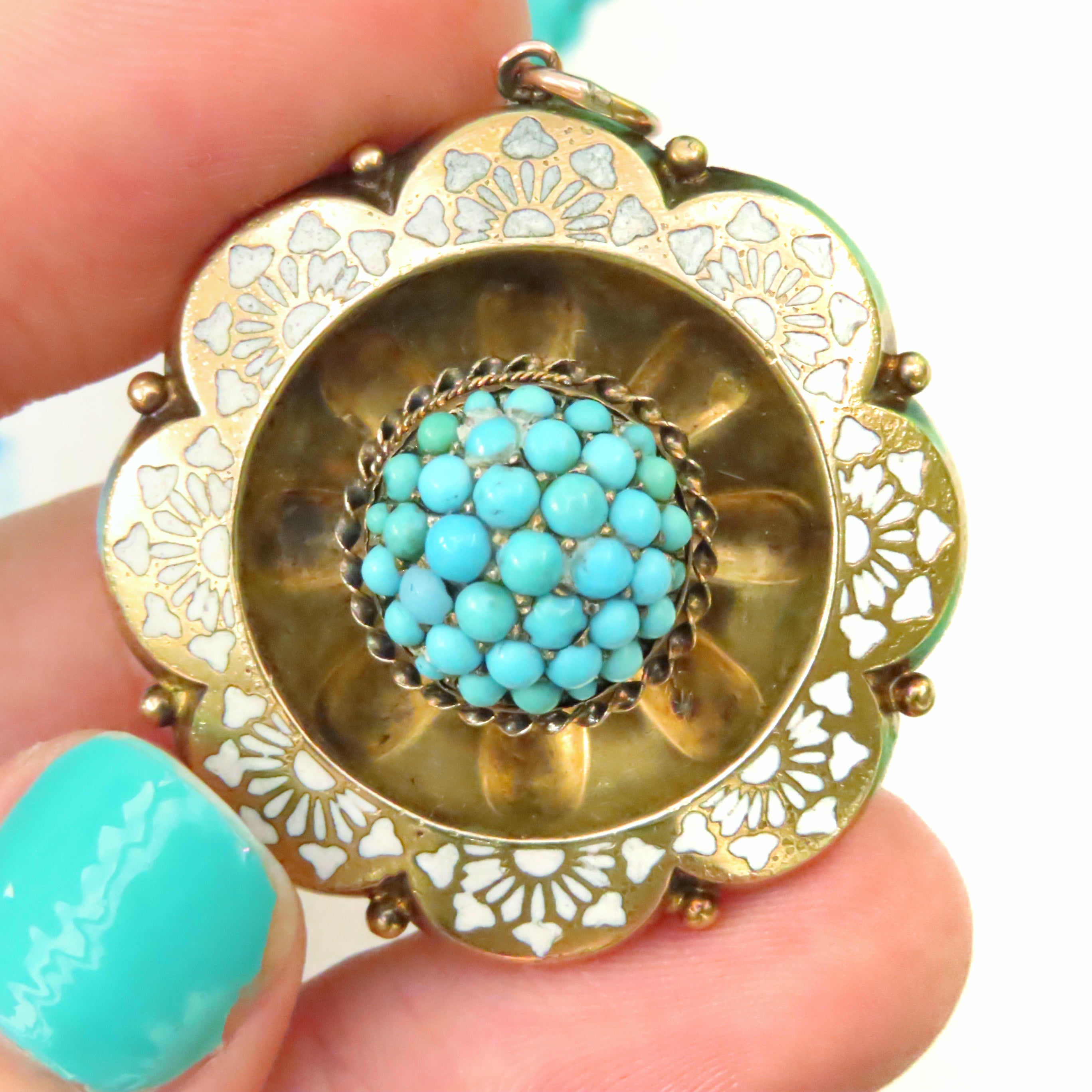 turquoise cabochon dome pendant with white enamel detail with a scalloped gold border in 12ct gold